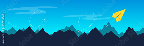 Origami paper plane flies over the mountains