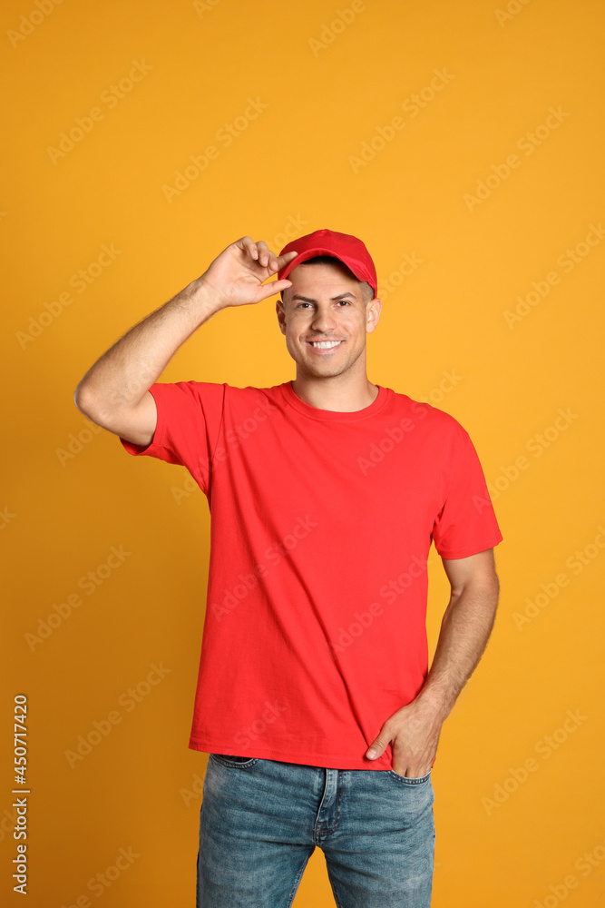 Happy man in red cap and tshirt on yellow background. Mockup for design Happy man in red cap and tshirt on yellow background. Mockup for design