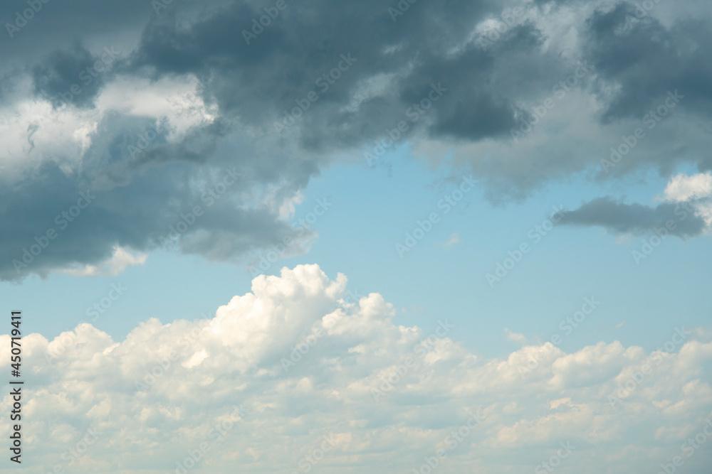 Blue sky background with stormy and white clouds.