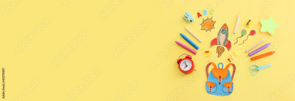 Back to school concept. Top view image of bag and student stationery over pastel yellow background Back to school concept. Top view image of bag and student stationery over pastel yellow background