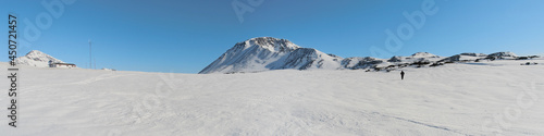 Panorama of Greenland ice, mountains in background, blue sky above © Barry Thomas, UK