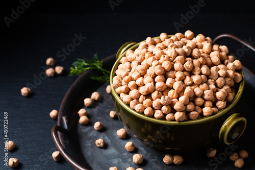 Food ingredient concept rew Chickpeas in green bowl with black background with copy space photo