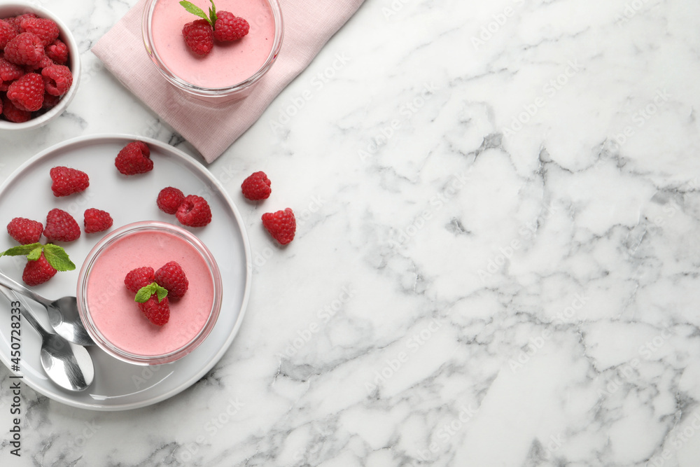 Delicious raspberry mousse with mint on white marble table, flat lay. Space for text Delicious raspberry mousse with mint on white marble table, flat lay. Space for text