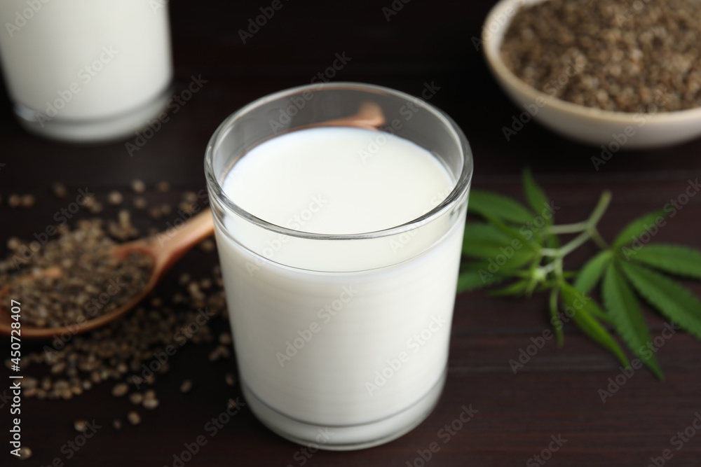 Glass of fresh hemp milk on wooden table Glass of fresh hemp milk on wooden table