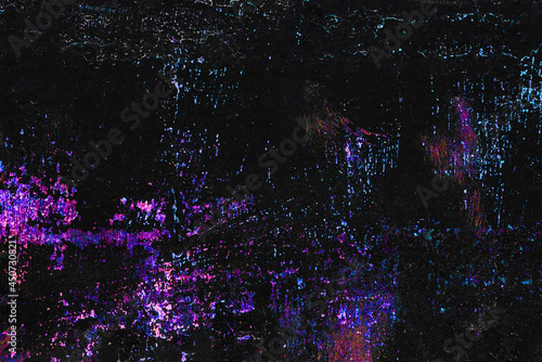 colorful shiny stitches, scratches, spots on black painted metallic background © nucia