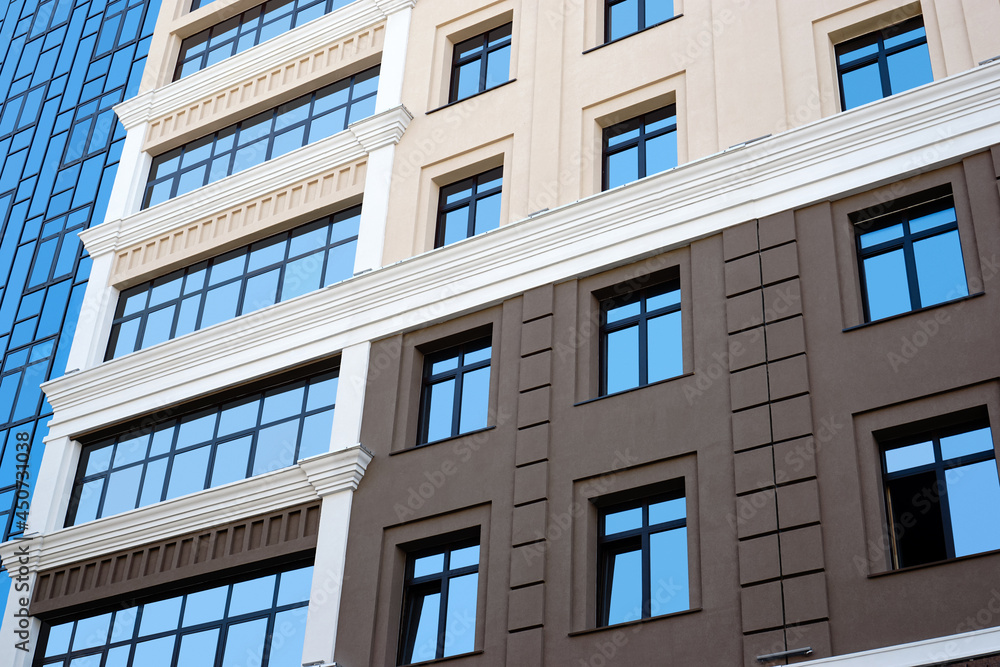 New high rise office building close up. Multistory house with glass facade. New high rise office building close up. Multistory house with glass facade.