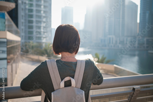 Bilde på lerret Happy young female traveler in the big city of Dubai, famous place Dubai marina