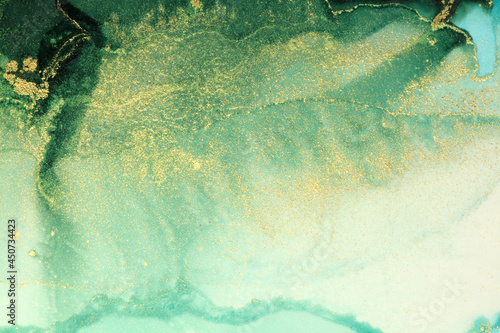 Art Abstract painting green and gold blots horizontal background. Alcohol ink colors. Marble texture.
