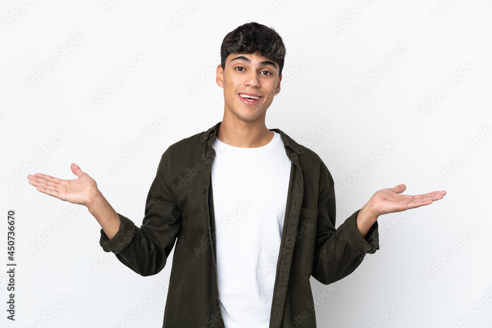 Young man over isolated white background with shocked facial expression Young man over isolated white background with shocked facial expression