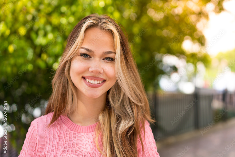 Young pretty blonde girl at outdoors With happy expression Young pretty blonde girl at outdoors With happy expression