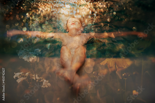 8 years old boy relaxing in golden water of a pool