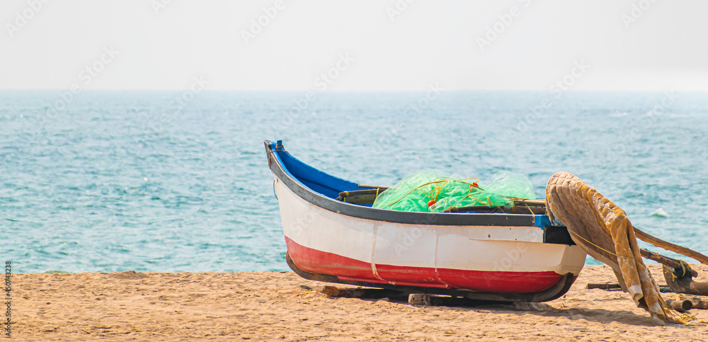boat parked on the beach in Goa, India