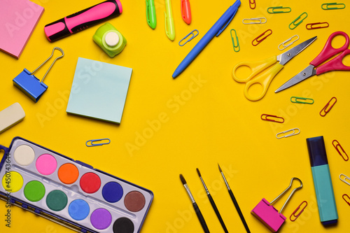 School accessories on yellow background, zenith view. Copy space. Back to school.