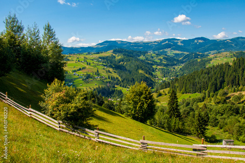 composite summer landscape, fence along the hillside meadows of the mountains. High quality photo