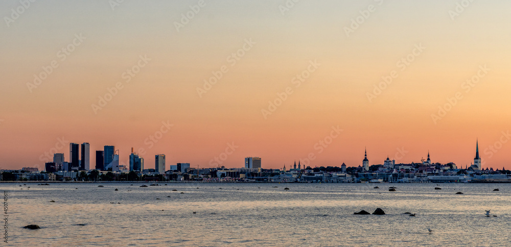 cityscape and skyline of Tallinn at sunset with colorful sky and copy space