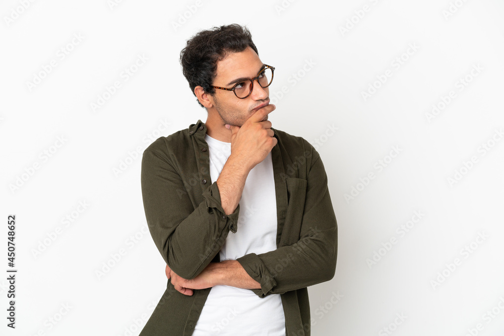 Caucasian handsome man over isolated white background having doubts and with confuse face expression Caucasian handsome man over isolated white background having doubts and with confuse face expression
