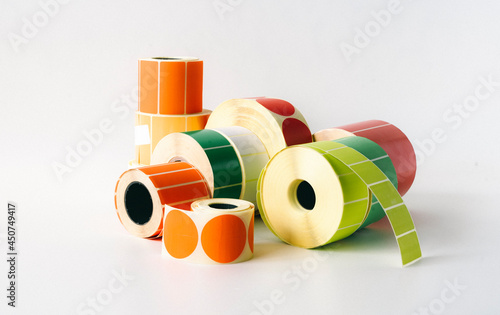 Colored and white rolls of thermal transfer printer labels. Various shapes for direct printing.
