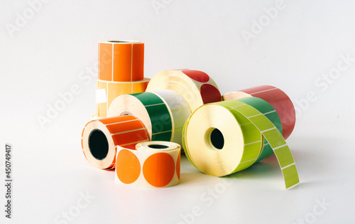 Colored and white rolls of thermal transfer printer labels. Various shapes for direct printing.