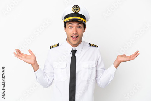 Airplane pilot over isolated white background with shocked facial expression