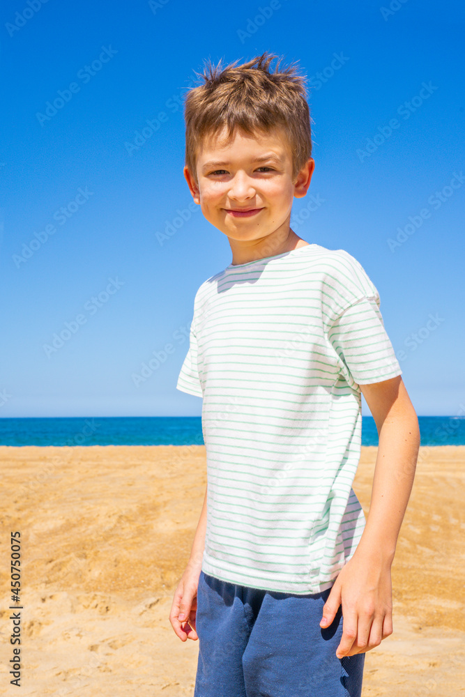 Happy boy standing on the summer beach. Young teenager relax and having fun in summer holiday vacation travel. High quality photo Happy boy standing on the summer beach. Young teenager relax and having fun in summer holiday vacation travel. High quality photo
