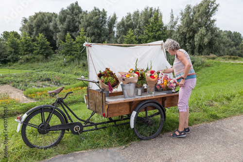 woman buyin flowers at flower stall photo