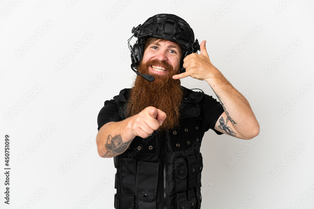 Redhead SWAT isolated on white background making phone gesture and pointing front Redhead SWAT isolated on white background making phone gesture and pointing front