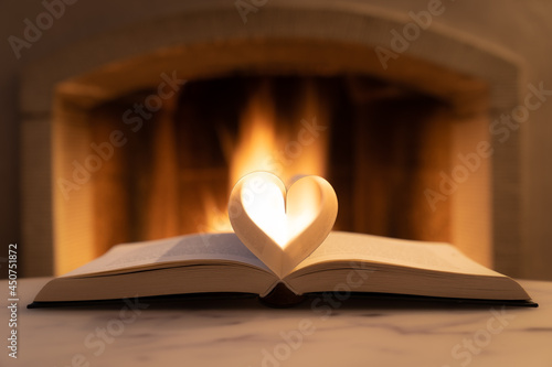 heart shaped book with ingel in the background photo