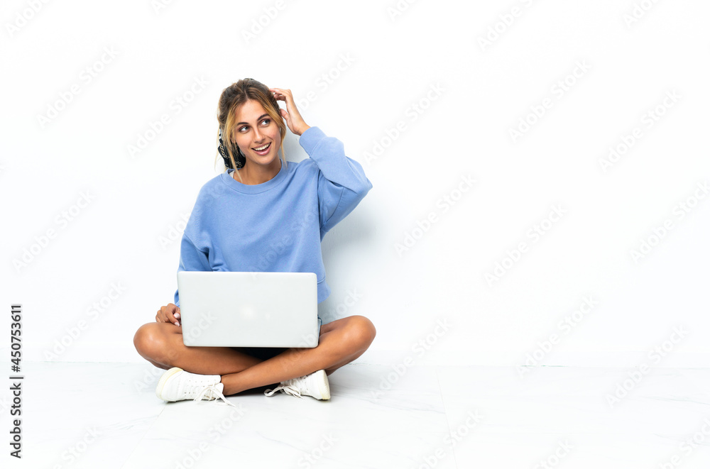Young blonde Uruguayan girl with the laptop isolated on white background thinking an idea Young blonde Uruguayan girl with the laptop isolated on white background thinking an idea