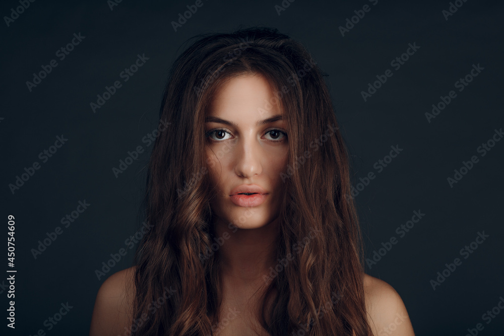 Portrait of beautiful young brunette woman with healthy hair.