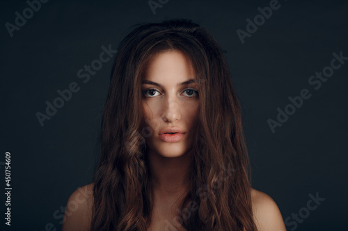 Portrait of beautiful young brunette woman with healthy hair.