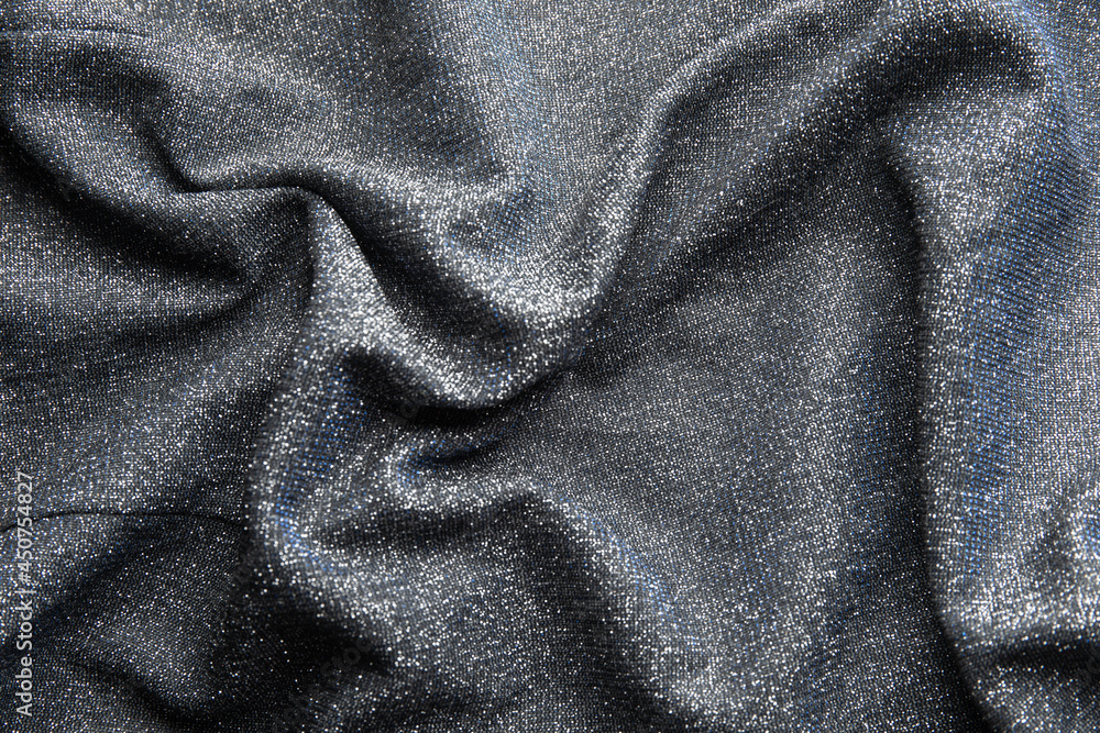 Fototapeta premium Fabric evening black dress girl with sequins, rhinestones. colorful sequined texture