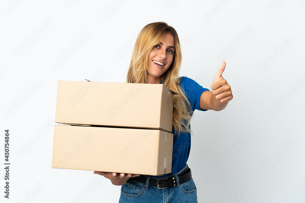 Young blonde Uruguayan delivery woman isolated on white background with thumbs up because something good has happened Young blonde Uruguayan delivery woman isolated on white background with thumbs up because something good has happened