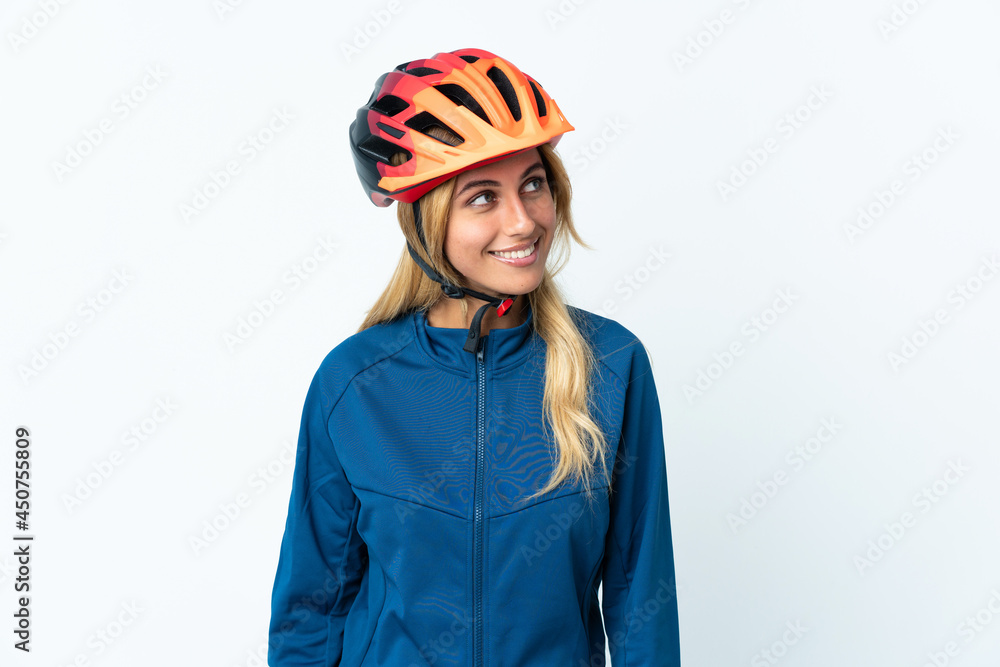 Young blonde Uruguayan cyclist woman isolated on background thinking an idea while looking up Young blonde Uruguayan cyclist woman isolated on background thinking an idea while looking up