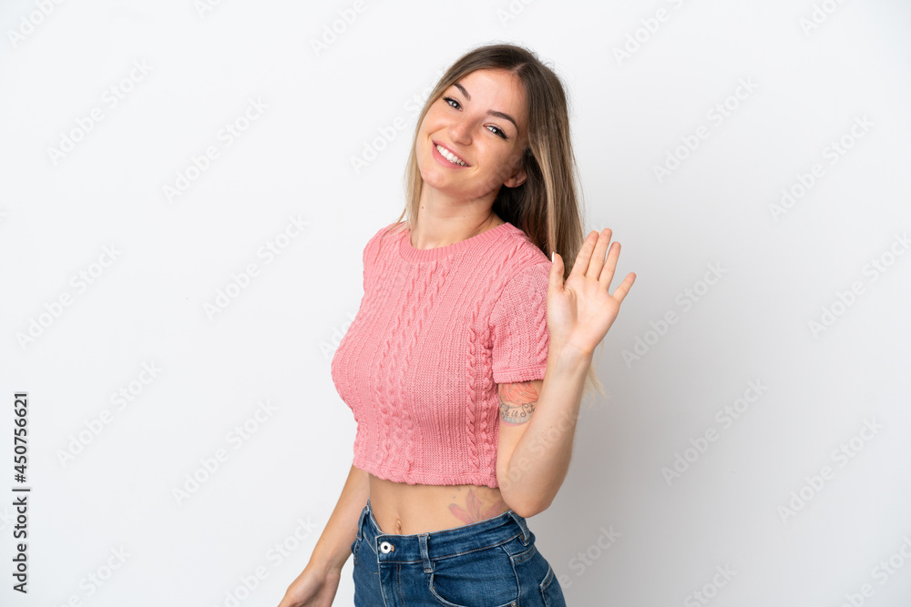 Young Romanian woman isolated on white background saluting with hand with happy expression Young Romanian woman isolated on white background saluting with hand with happy expression