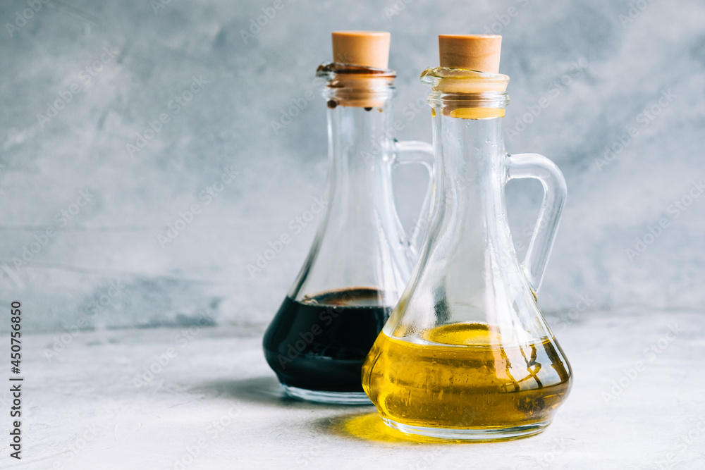 Olive oil and balsamic vinegar in bottles on the table. salad sauce Olive oil and balsamic vinegar in bottles on the table. salad sauce