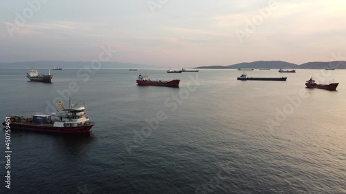 Elevator tracking shot of a drone over ships anchored in the Turkish Sea of Marmara near Istanbul with the Princes Islands in the background photo
