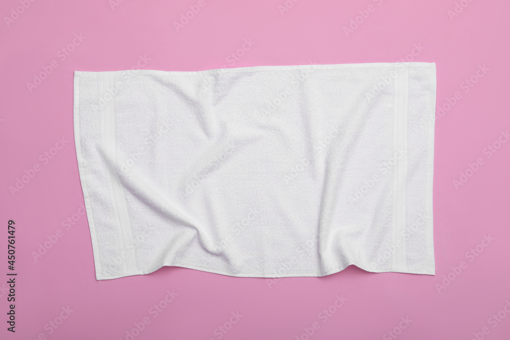 Crumpled white beach towel on pink background, top view Crumpled white beach towel on pink background, top view