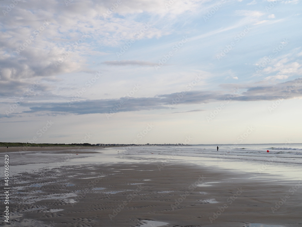 lonely fisherman on low tide beach in Maine lonely fisherman on low tide beach in Maine