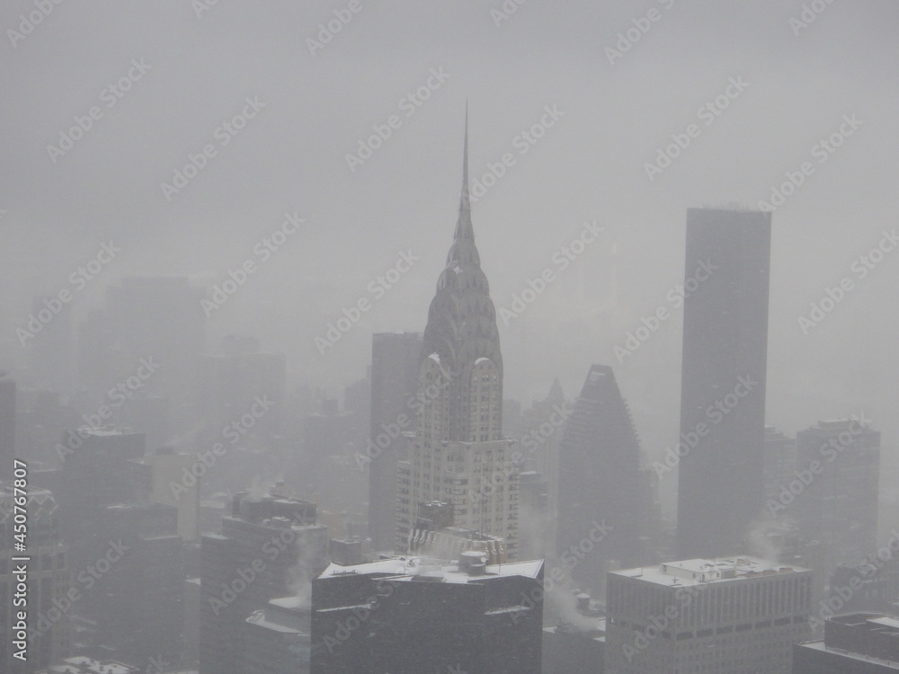 New York over snow and the Chrysler building trying to be visible.