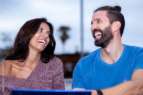 Couple of friends laughing and happy while they search on internet.
