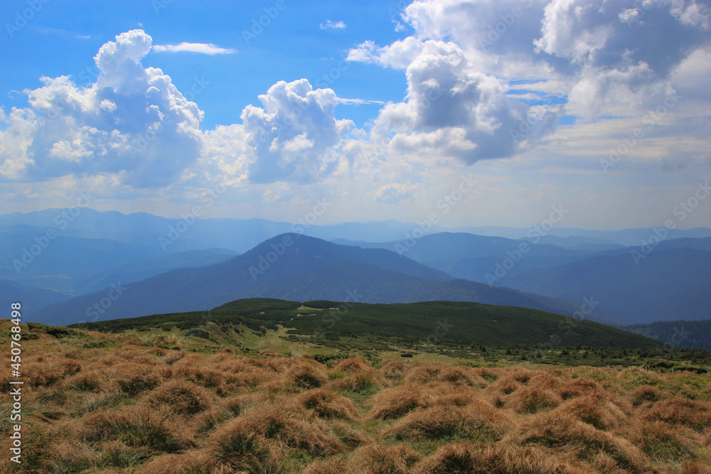Beautiful mountain landscape, blue sky, lush clouds, high mountains, grass, green tourism Beautiful mountain landscape, blue sky, lush clouds, high mountains, grass, green tourism