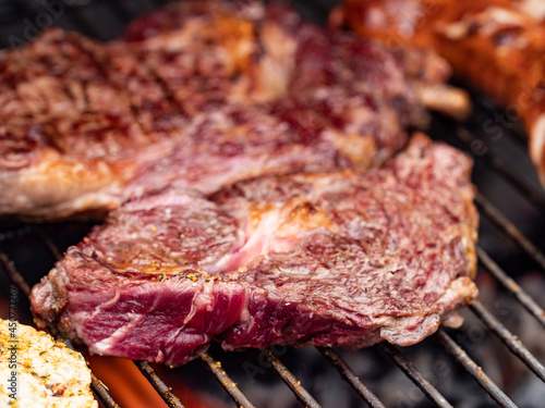 Barbecue in the summer. Close-up of grilled steaks. The meat is rare inside and roasted on the outside. 