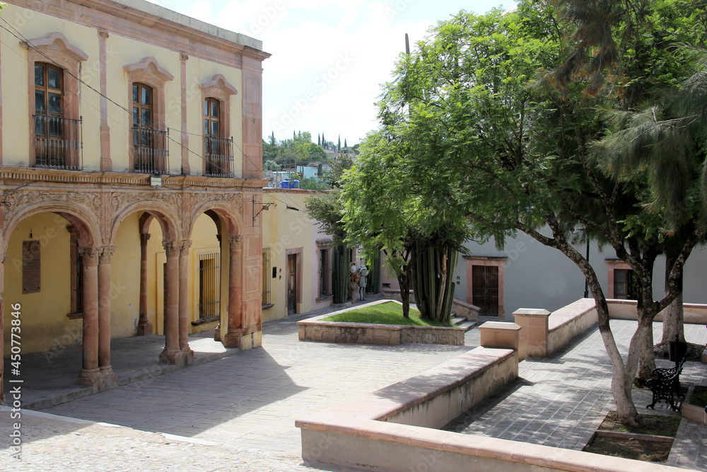 Colorful colonial streets with large windows and beautiful parks with benches of the Mineral de Pozos town in the city Guanajuato Mexico
