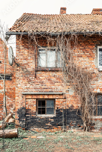 Facade of old German brick house with burnt wall in poor condition