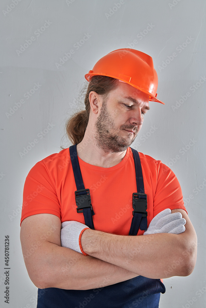 chic portrait of a builder on a wall background chic portrait of a builder on a wall background