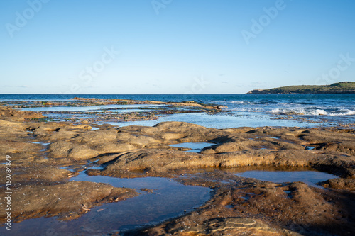 view of waves hitting rocks at the seaside