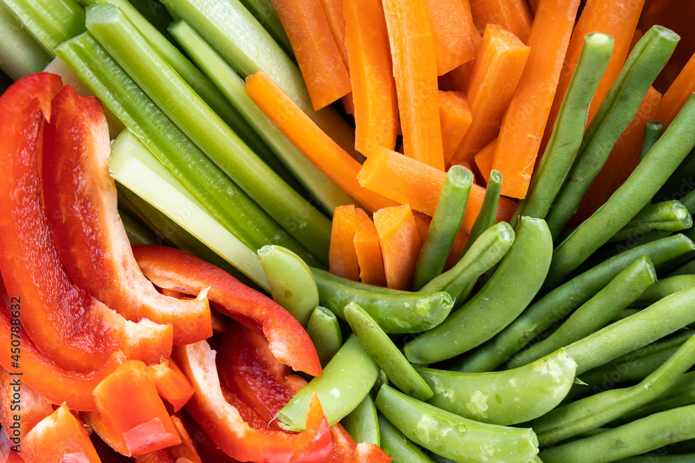 A close up rainbow of healthy fresh organic vegetables cut up into strips ready to be eaten A close up rainbow of healthy fresh organic vegetables cut up into strips ready to be eaten