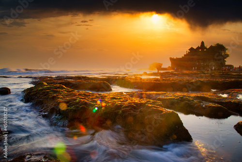 beautiful landscape of hinduism temple located in Tanah Lot Bali Bali at sunset with sun light sky background