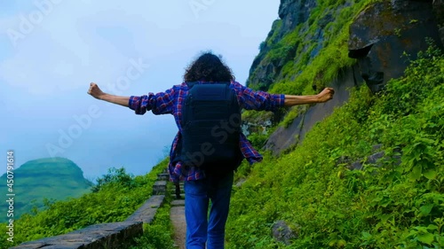 hiker in the mountains and enjoying travel concept