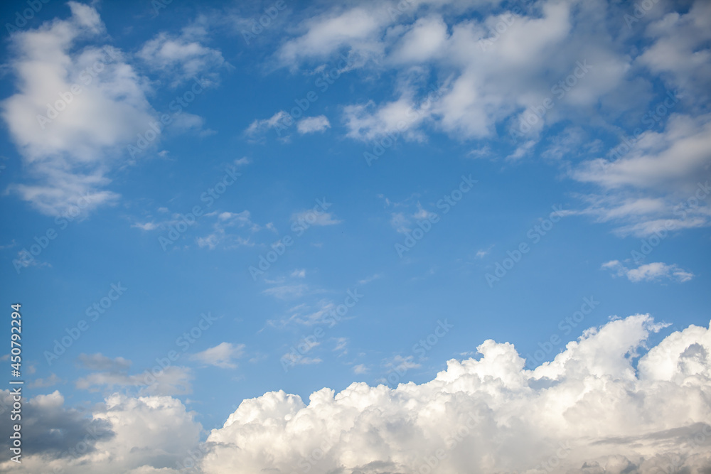Big white clouds in a blue sky close-up. There is a place for the text Big white clouds in a blue sky close-up. There is a place for the text